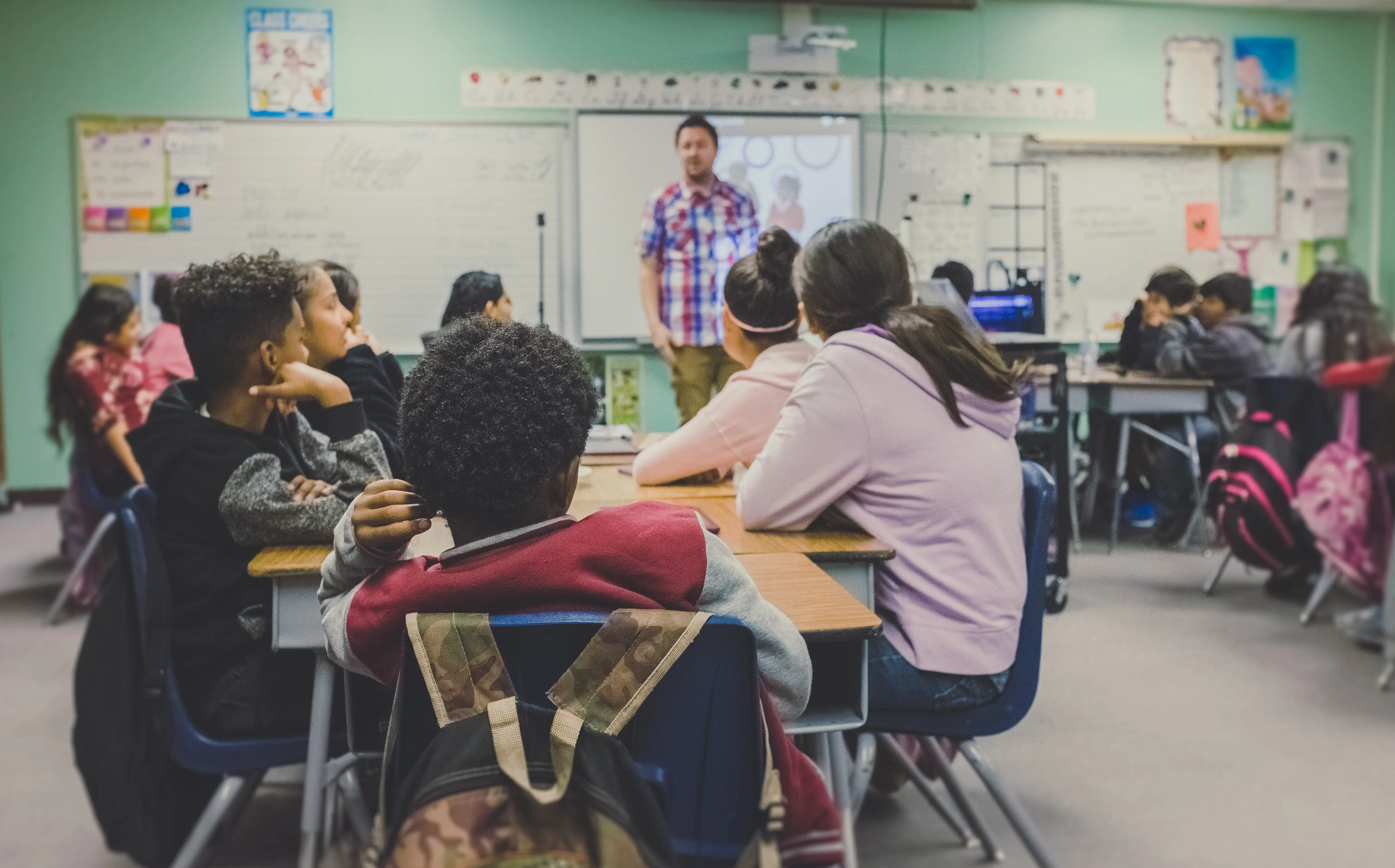 A classroom with students and a teacher